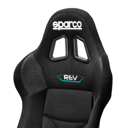 Detail of the black racing seat showing headrest and logo.