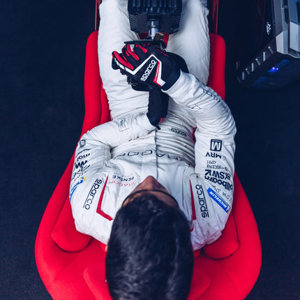 Lifestyle shot of black and red sim racing gloves with stylish design.