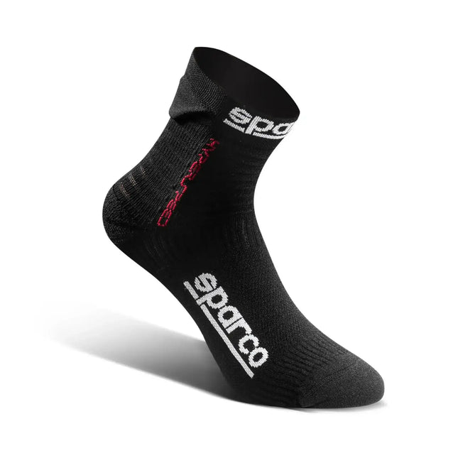 Detail of black racing socks with red logo on a white background